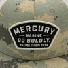 Image of a camo cap with tan mesh back and black and tan Mercury patch on the front