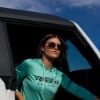 Woman sitting in vehicle wearing Mercury Racing Storm Creek Women’s Hooded Long Sleeve