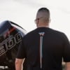 Mercury Racing Stripes Performance Tee worn on man next to engine