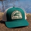 Mercury Outfitter Hat in front of a river